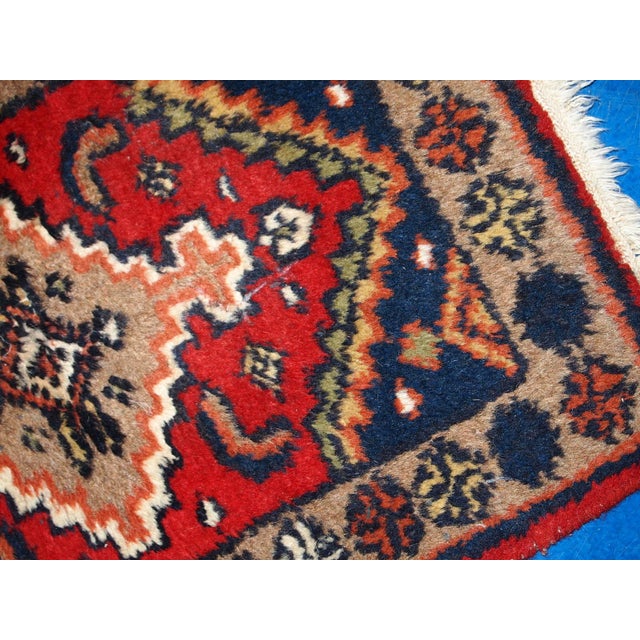 This Handmade Vintage Hamadan Style Rug from the 1970s is a beautiful piece of craftsmanship that embodies the rich...