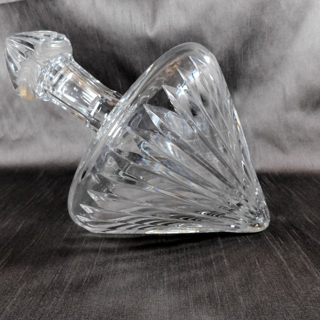 This is a cut crystal lay down decanter with a matching stopper. It has a flat panel-a spot to lay it down on, but it has...