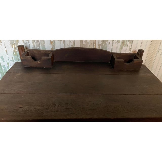 This is a great primitive writing desk with bark covered legs and base and stained wood (maybe oak?) upper. It would be...