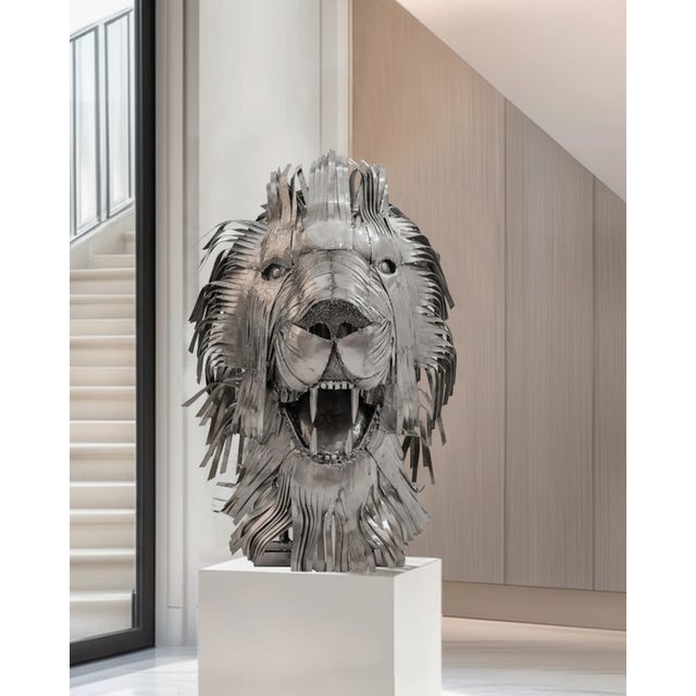 One-of-a-kind contemporary lion head sculpture handcrafted from recycled steel, featuring a powerful frontal composition...