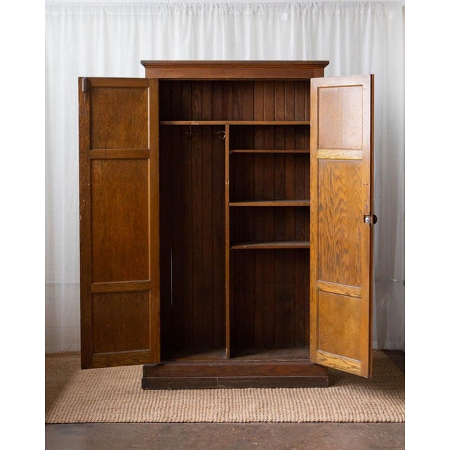 This early 20th-century oak school locker from the Cleveland, Ohio Public School system is a striking and highly...