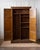 This early 20th-century oak school locker from the Cleveland, Ohio Public School system is a striking and highly...