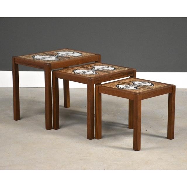 A set of 3 mid century modern nesting tables. Made in Denmark. Professionally refinished. Circa 1960’s. Tile inserts...