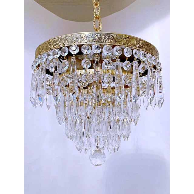 This is an Italian brass rim chandelier dressed with octagon chain and U-drop crystals drops. It has 3 Edison base...