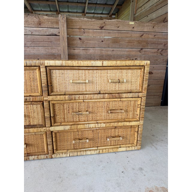 Beautiful vintage six-drawer dresser showcasing an exceptional blend of pencil reed, woven rattan, bamboo, and cane. The...