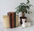 Pair of vintage cream and gold colored leather wrapped bookends. No makers mark. Some age wear to leather. Pictured.