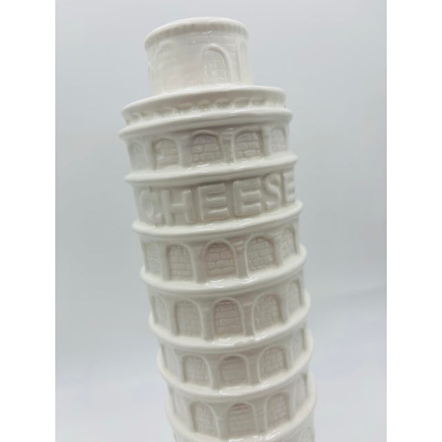Add a bit of travels to your italian dinner with this leaning tower of Pisa parmesan cheese shaker. Glazed in white &...