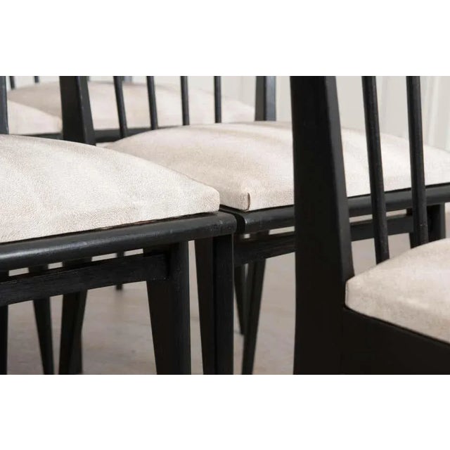 A smart set of dining chairs from early to mid-20th century France, recently updated in ebonized (black painted) finish to...