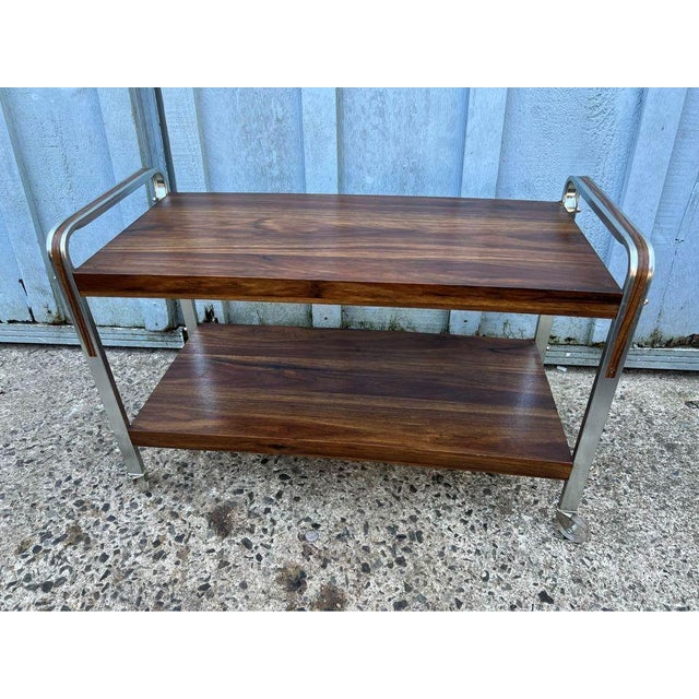Mid-Century Modern Retro Style Two-Tier Rolling Utility Cart. with wheels it features with featuring a sleek design with...
