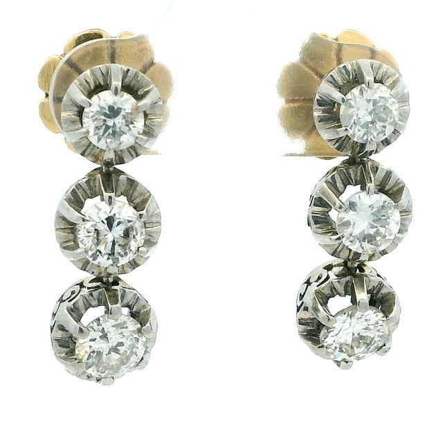 A refined pair of vintage diamond drop earrings crafted in platinum and 14 karat yellow gold, showcasing an elegant...