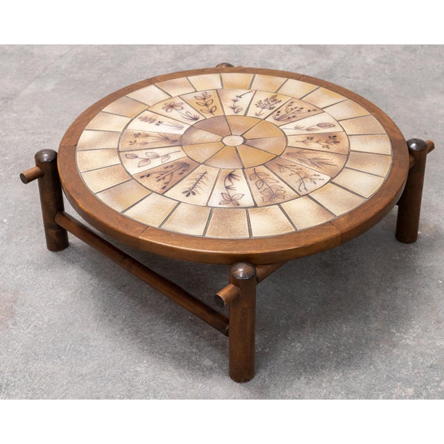 The charm of this 1960s coffee table lies in its magnificent ceramic top and solid wood frame. The botanical motifs are...
