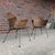 This is a pair of vintage Salterini wicker and iron lounge chairs believed to be from the 1950s.