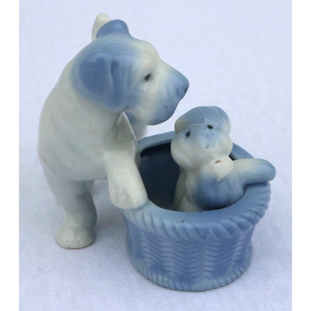 Adorable blue and white terrier figurine. This figurine features the mom with her puppies in a basket. I love the blue and...