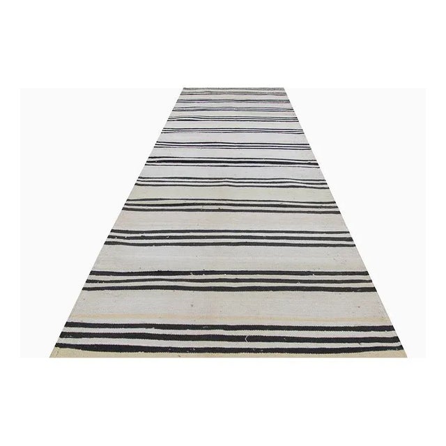 ACTUAL SIZE: 3’0″ x 12’7″ PRIMARY COLOR: Ivory / Black AGE: New MATERIALS: Wool FOUNDATION: Cotton PRODUCTION: Handwoven,...