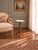 An elegant French guéridon side table featuring a circular Carrara marble top encircled by a pierced brass gallery....