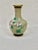 Beautiful vintage cloisonne vase. Floral detailing. Features several different flowers and a geometric pattern band on the...