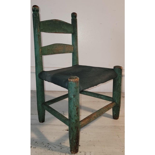 19th c Child's Ladder back in original Green paint. The seat has been reupholstered with a beautiful green leather.