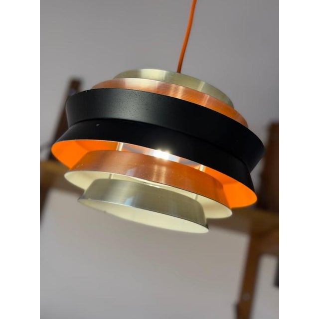 A fiery classic: This Trava pendant lamp by Carl Thore for Granhaga Metallindustri is a real eye-catcher, showcasing...