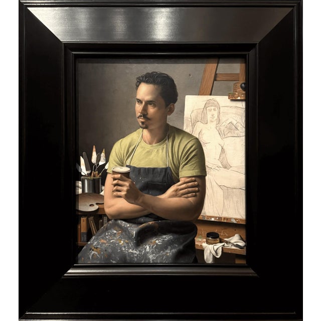 The painting depicts a contemplative figure seated in an artist's studio, holding a cup while gazing thoughtfully at a...