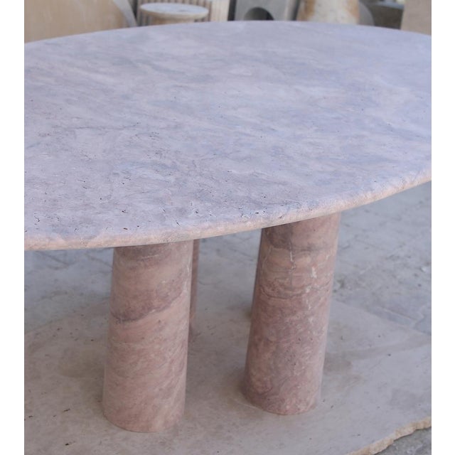 This minimalist table is made from one material, a high quality Red Travertine. Featuring a curved edge top that elegantly...