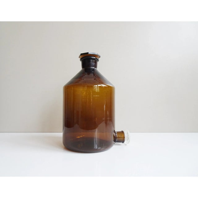This large pharmacist bottle consists of high -quality thick glass with two polished glass closures from the 1960s. The...