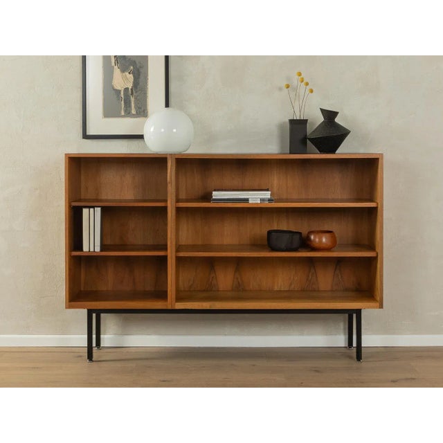 Classic Scandinavian style sideboard from the 1950s. Body in walnut veneer with four shelves and new square steel feet in...