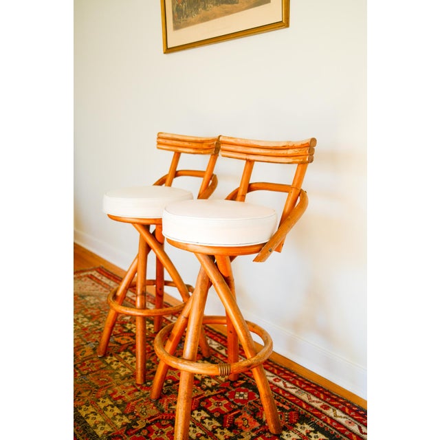 Good condition pair of vintage bamboo rattan swivel bar stools. Paul Frankl style. 1970's era. Perfect for a palm beach or...