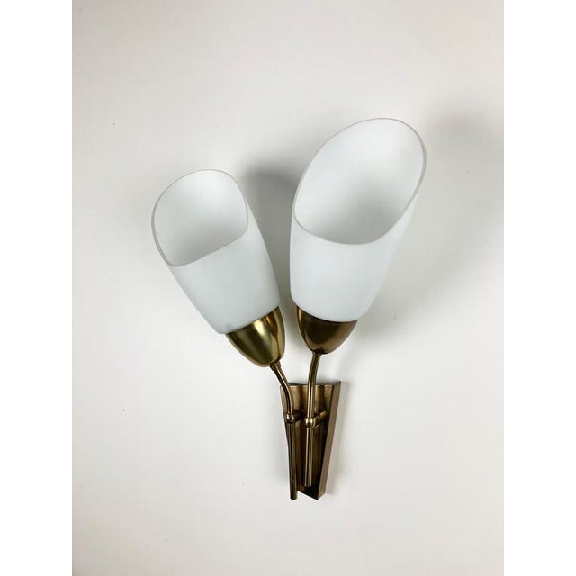 Design mid-century wall lamp by kamenicky senov in 1960s. Opaline glass shades can be adjusting by rotation to create...