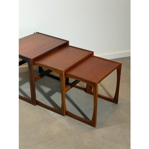 A beautiful mid-century modern G-Plan Quadrille nest of three tables, crafted in richly grained teak and featuring the...