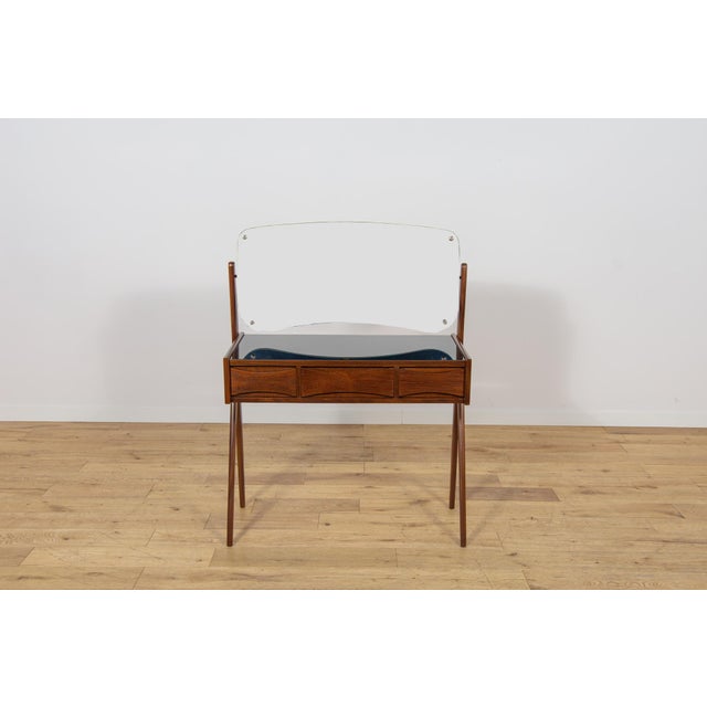 This teak dressing table was designed by Arne Vodder for the renowned Danish manufacturer Ølholm Møbelfabrik in the 1960s....