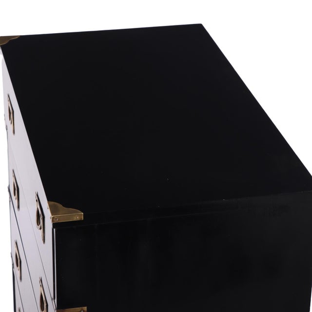 A stately tall chest of drawers in sleek, ebonized mahogany, exemplifying the refined proportions and utilitarian elegance...