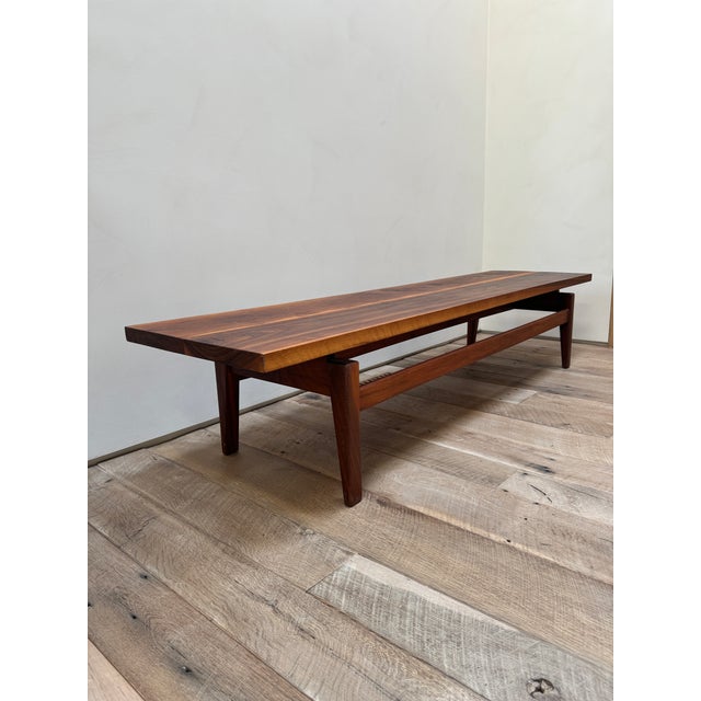 Vintage midcentury 1960s modern walnut coffee table. Iconic "floating" top designed to function as either a cocktail table...