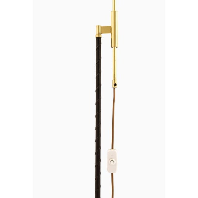 This pair of height-adjustable floor lamps, produced by möllers armatur eskilstuna (mae) in sweden during the 1960s, is a...