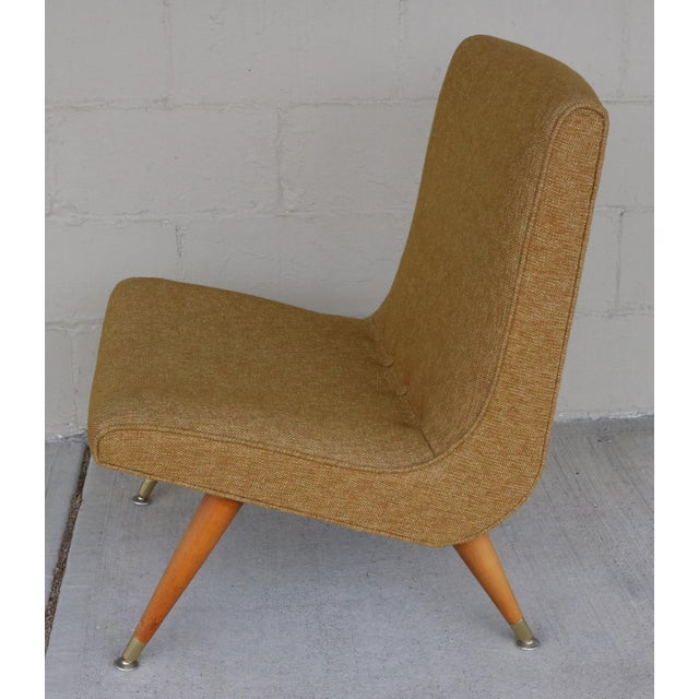 Fantastic mid-century lounge chair with metal tipped walnut legs. The fabric on this chair is a durable gold mustard color...