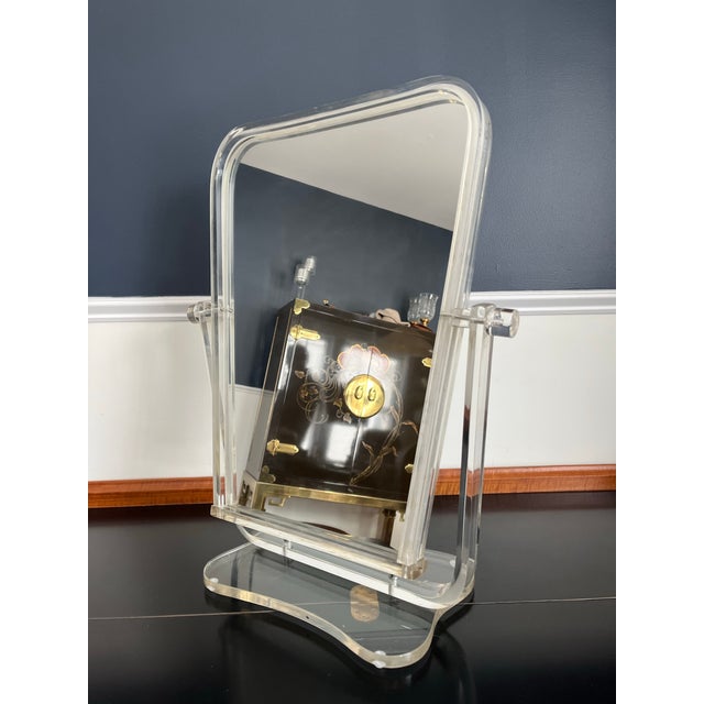 Fantastic mid century lucite vanity mirror. Great Hollywood Regency Art Deco design. Two sided mirror with tilt mechanism.