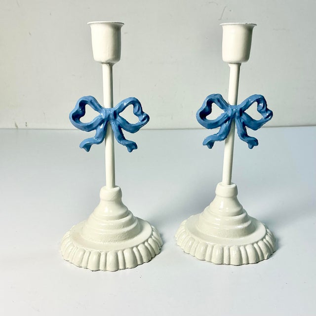 This pair of cast iron Candlestick Holders are delightful. They feature a French Blue Bow on an ivory stem, base and...