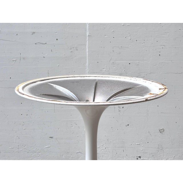 The iconic "Tulip" dining table was designed by Eero Saarinen for Knoll International in 1956 and is considered one of the...