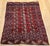 A refined early 20th century Turkmen Tekke area rug showcasing a detailed allover geometric gul medallion design of...