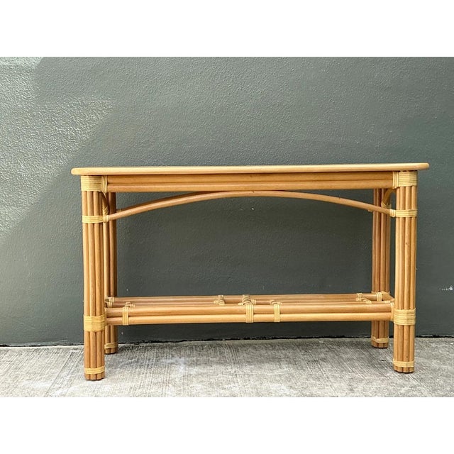 This vintage rattan console table pairs organic natural materials with a light, airy silhouette, ideal for casual coastal...