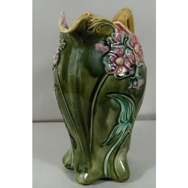 Majolica pitcher with pink flowers on a green background signed Onnaing, circa 1900. A excellent example of the Art...