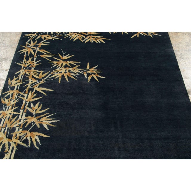 Hand-knotted in wool, this 4x6 contemporary Art Deco rug features a dramatic midnight blue field adorned with elegant,...