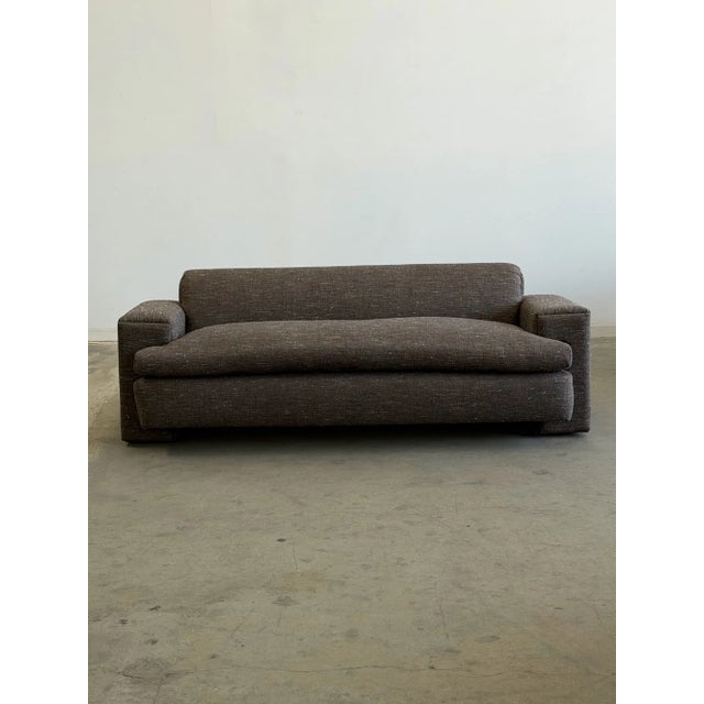 W83 D36 H28 SW64 SD25 SH23 AH24 A striking post modern sofa, freshly reupholstered in a speckled grayish tweed. The sofa...