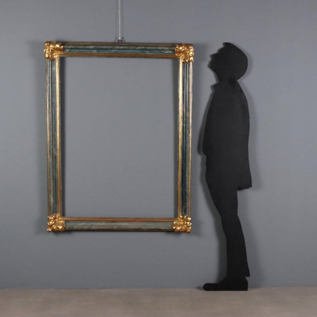 Painted and gilded Baroque frame. Molded frame with faux marble and gold finish, gilded leaf carvings at the four corners....
