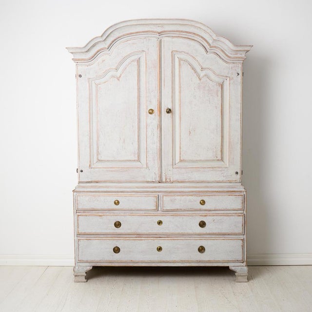 Genuine Swedish rococo cabinet from the late 1700s. The cabinet is made in two parts and very well crafted from solid pine...