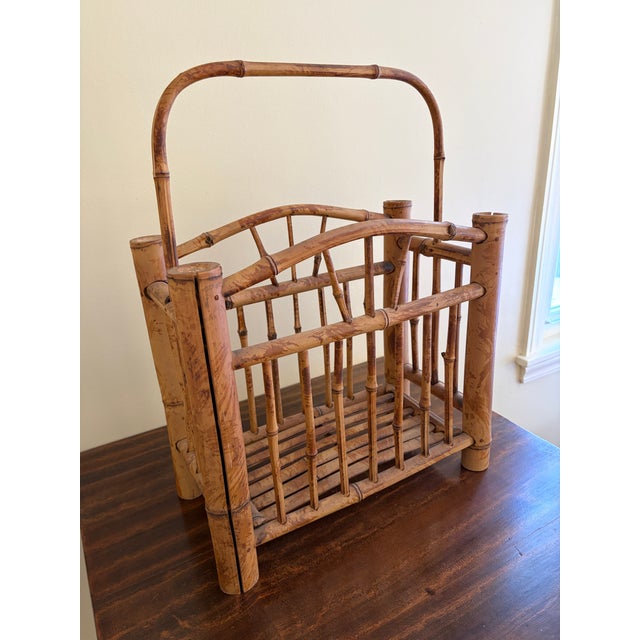 A beautifully proportioned mid-century bamboo magazine rack dating to the 1960s, crafted in the Hollywood Regency...