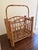 A beautifully proportioned mid-century bamboo magazine rack dating to the 1960s, crafted in the Hollywood Regency...