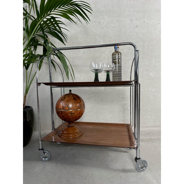Handy vintage serving trolley in metal (chrome) and plywood. Has a somewhat industrial character. Marked: Gerlinol. When...