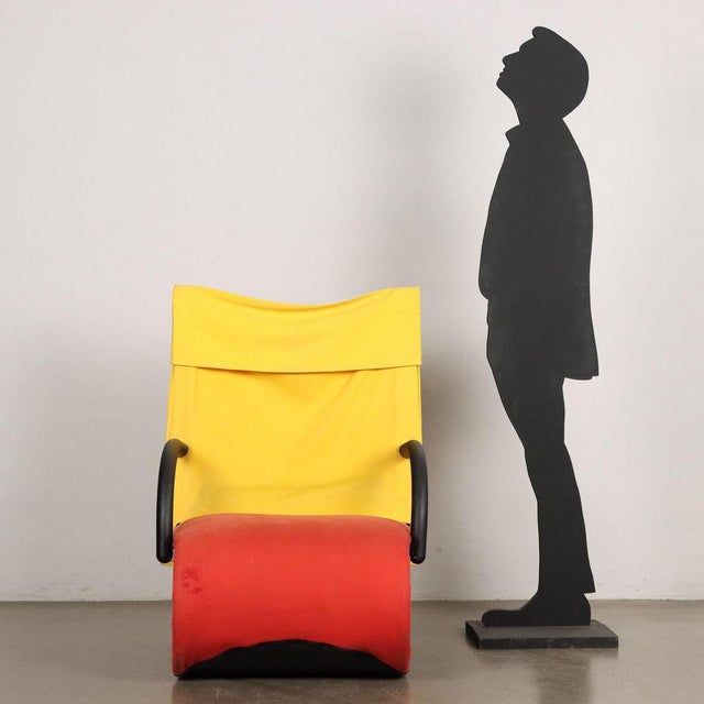 Armchair with metal structure, foam padding and fabric covering. This piece is attributed to the mentioned designer/maker....