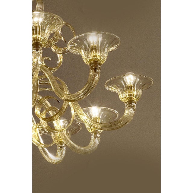 Elegant scenographic chandelier in champagne color made in Murano glass and gold24 k plated metal frame. For classical and...