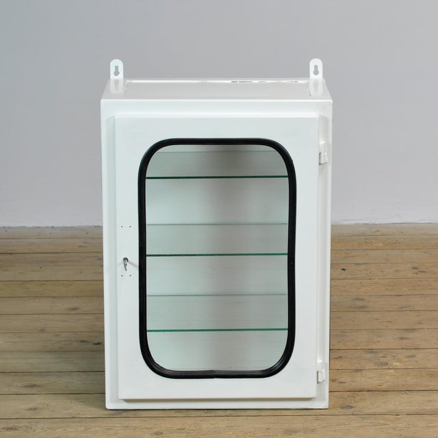 Medicine cabinet (wall unit) from a hospital. Made of iron and glass that is clamped into the steel by a rubber strip....